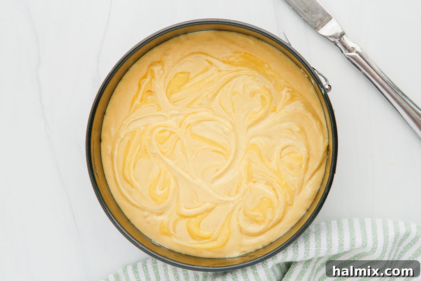 Zesty Instant Pot Lemon Cake 6 Lemon curd beautifully swirled into the cake batter with a toothpick, ready for cooking in the Instant Pot.