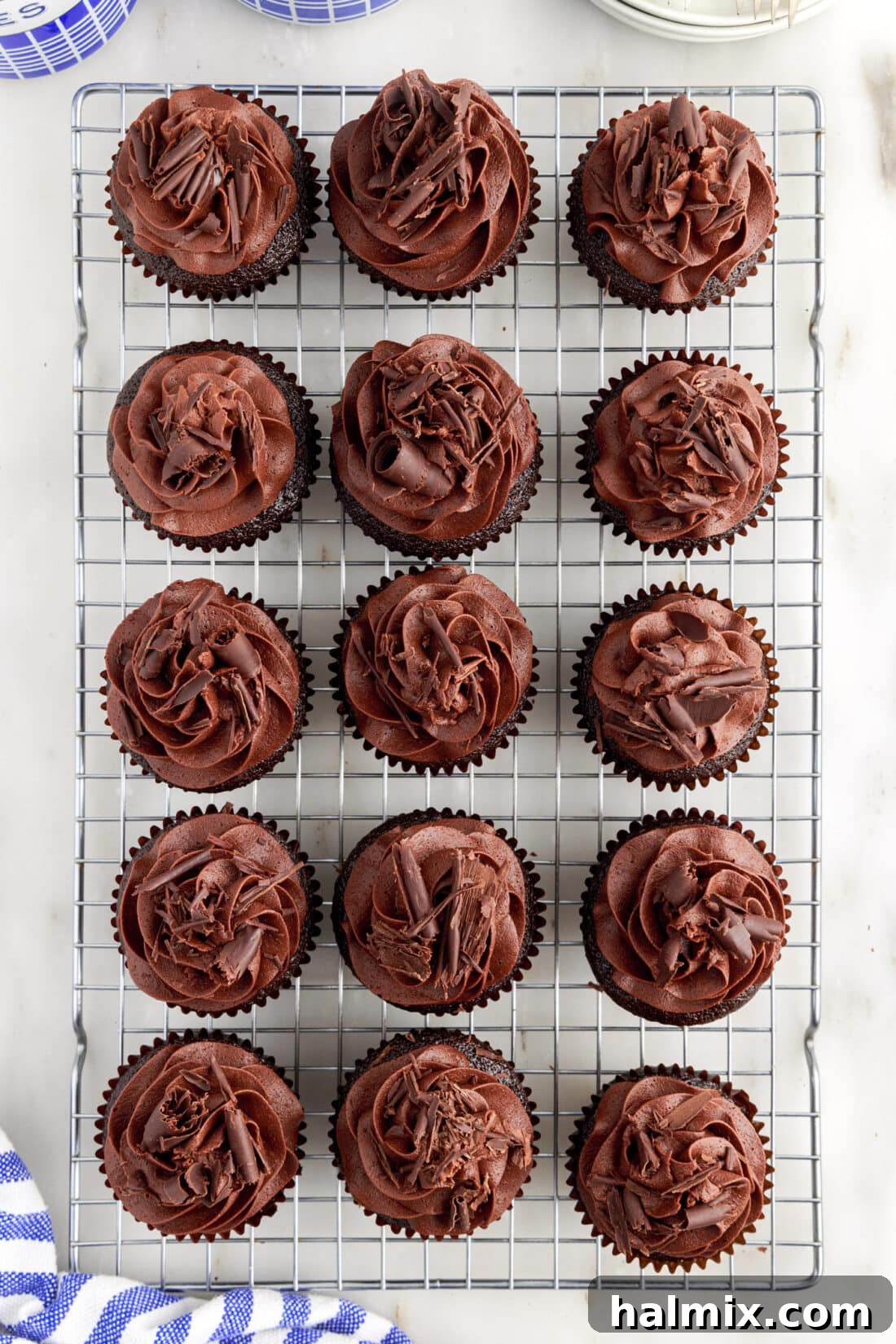 Decadent Double Chocolate Delights 12 Frosted Double Chocolate Cupcakes arranged artfully on a wire cooling rack, ready for serving.