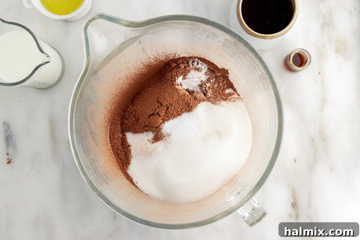 Decadent Double Chocolate Delights 5 chocolate cupcake dry ingredients in a mixing bowl, showing a well-combined powdery mixture.