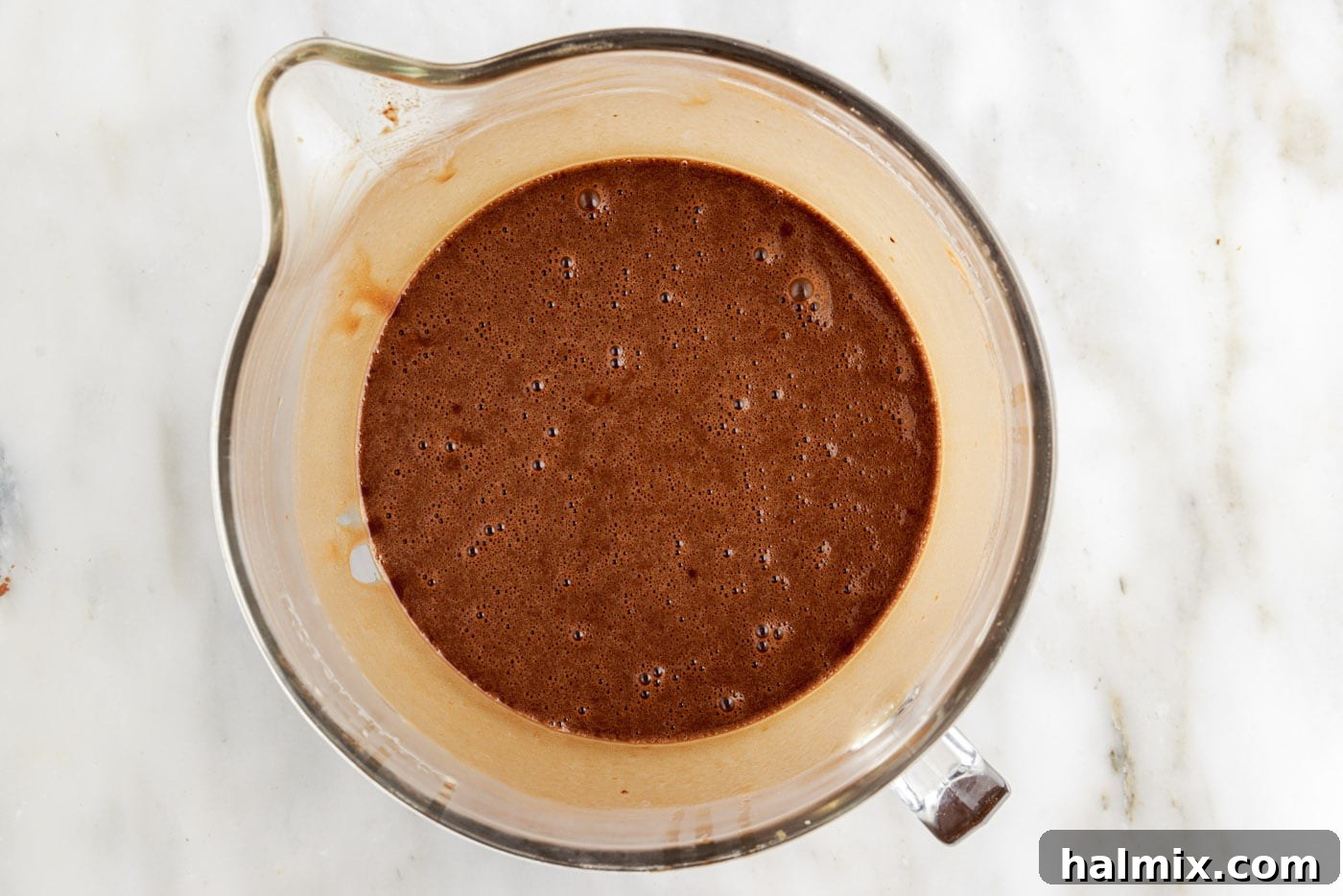 Decadent Double Chocolate Delights 7 smooth, thin chocolate cupcake batter in a mixing bowl after being combined.