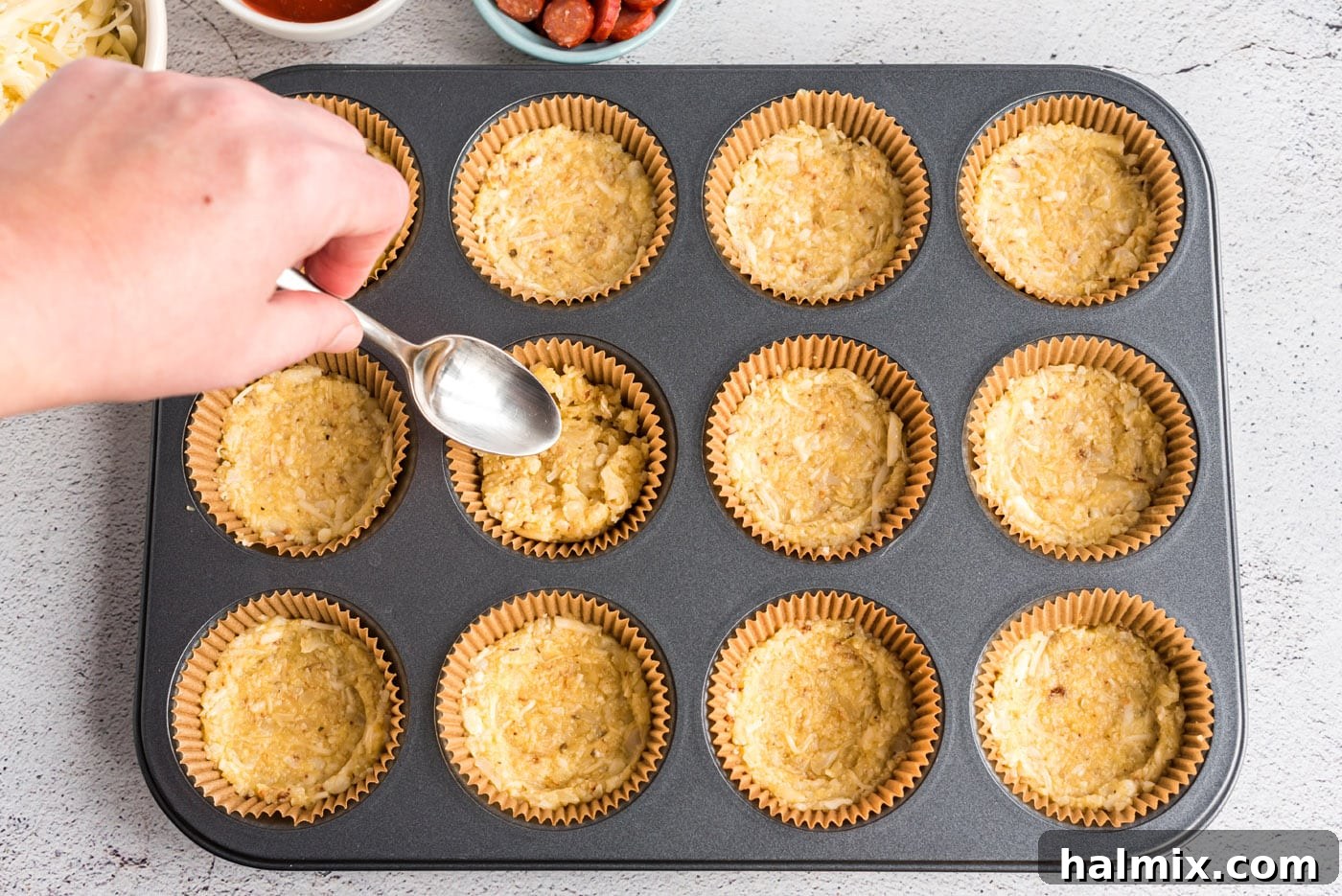 Cauliflower Pizza Poppers 6 flattening cauliflower crust in muffin tin