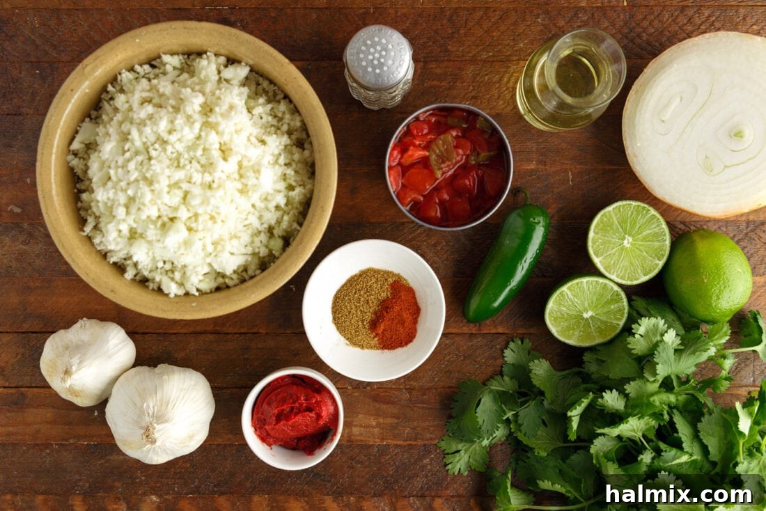 Zesty Mexican Cauli Rice 4 Fresh ingredients laid out for Mexican Cauliflower Rice: riced cauliflower, Rotel tomatoes, tomato paste, onion, garlic, cumin, chili powder, lime, and cilantro.