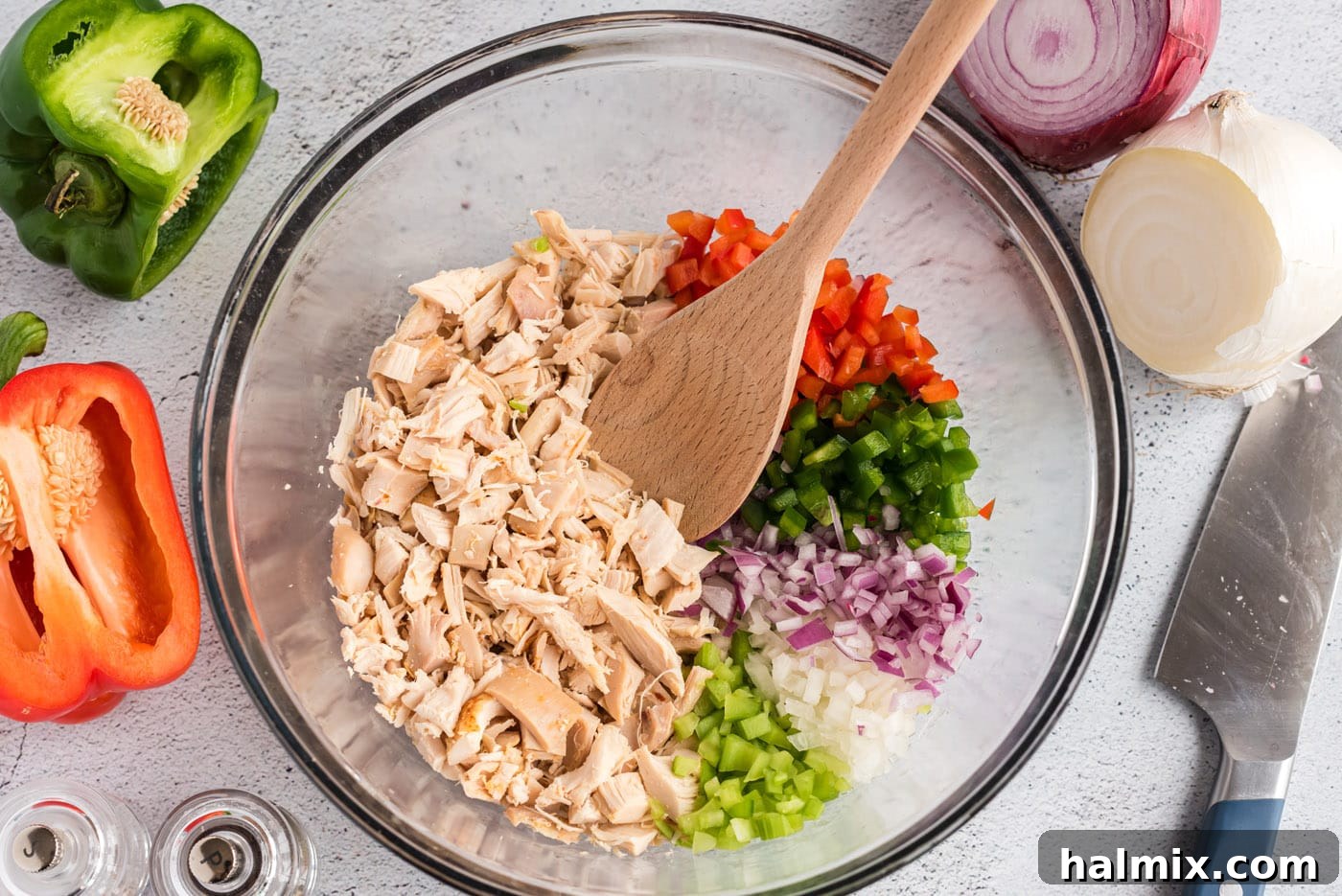 Chopped chicken, celery, green and red bell pepper, and onion in a large mixing bowl