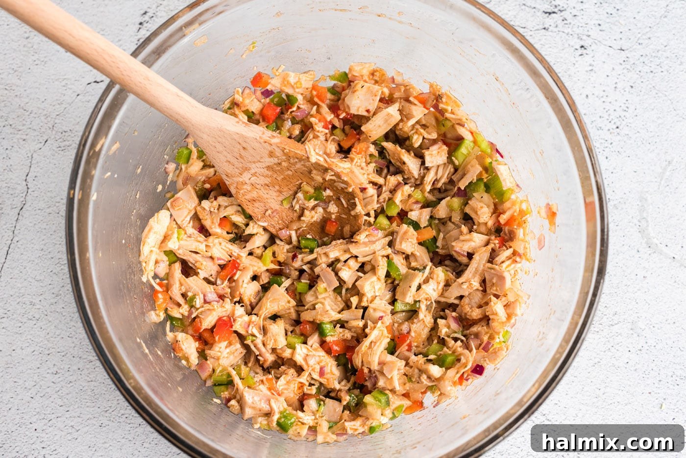 Cajun Chicken Salad chilling in a covered bowl in the refrigerator