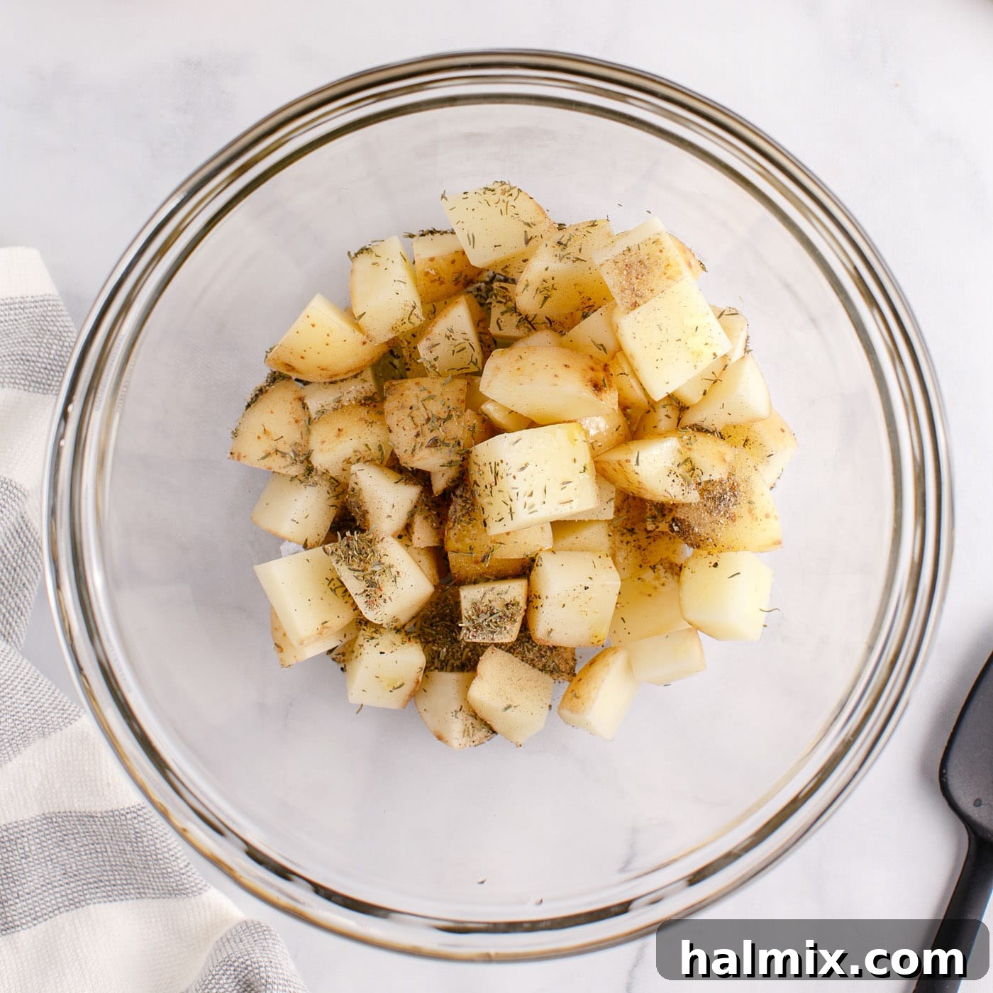 Sizzling Corned Beef and Potato Medley 5 Cubed potatoes in a bowl with seasonings and oil