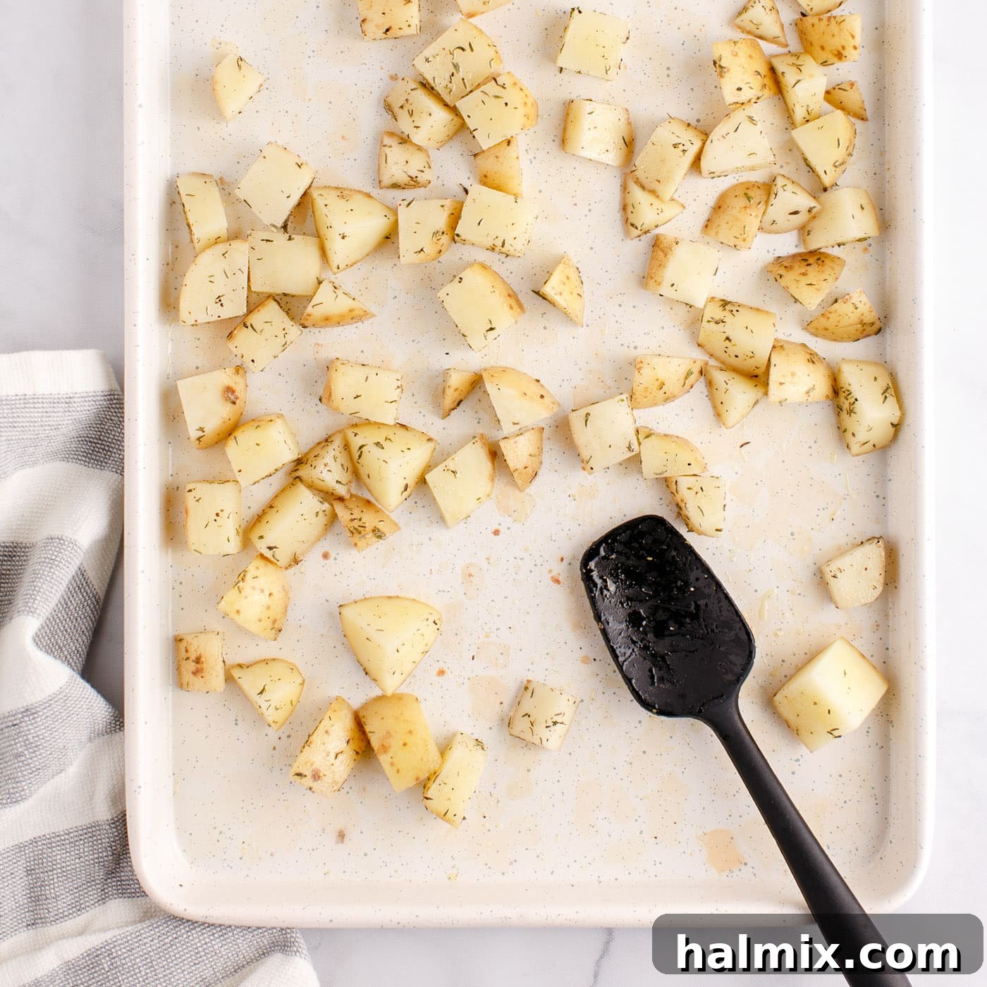 Sizzling Corned Beef and Potato Medley 6 Cubed potatoes on a baking sheet, ready for the oven