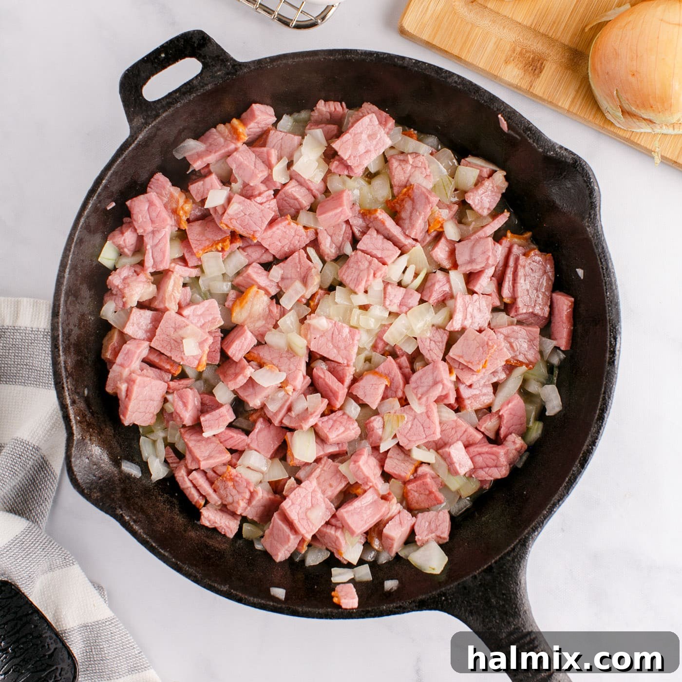 Sizzling Corned Beef and Potato Medley 8 Corned beef and onions cooking in a skillet