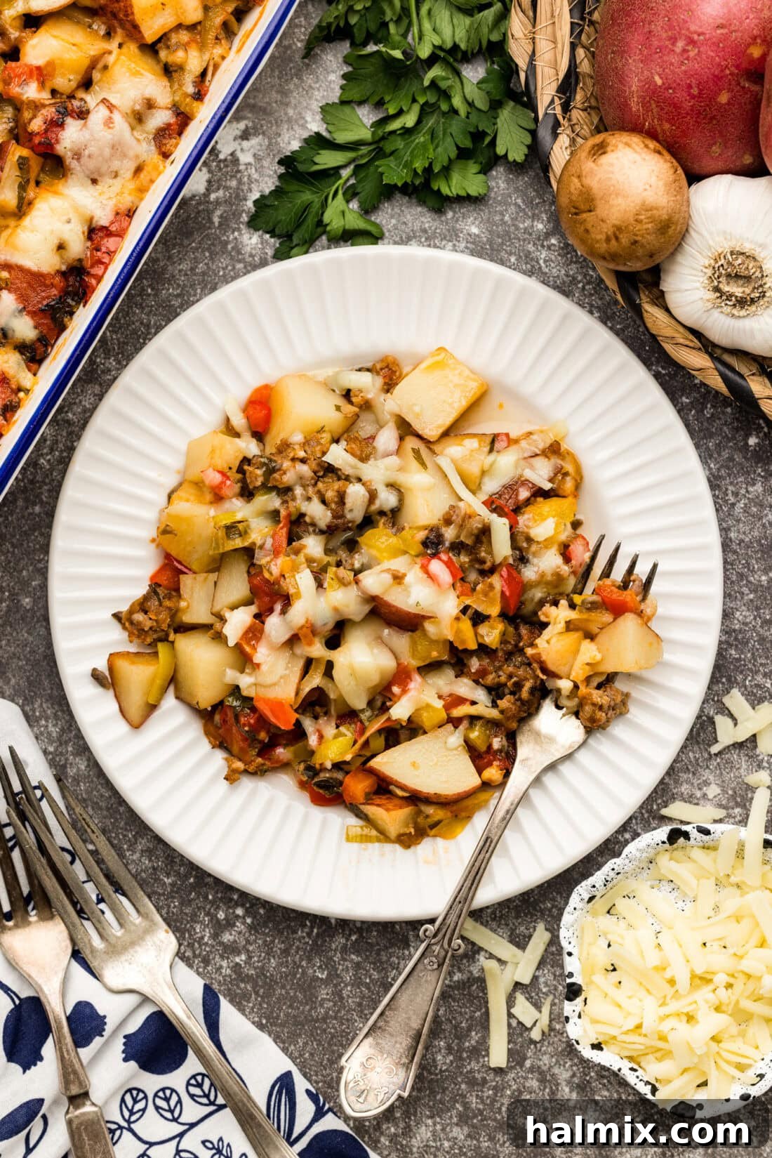 Hearty Sausage and Potato Bake 2 Plate of Sausage and Potato Casserole with a fork on the side, showcasing the rich, rustic flavors.