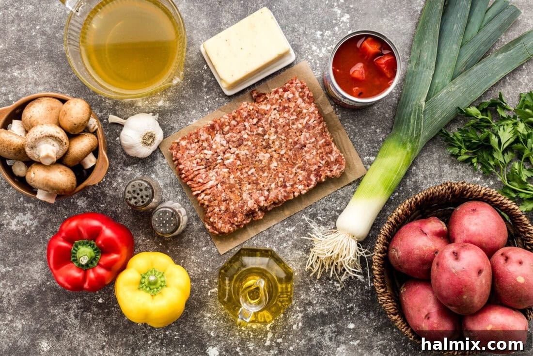 Hearty Sausage and Potato Bake 4 A vibrant selection of ingredients for Sausage and Potato Casserole laid out on a cutting board, including fresh vegetables, sausage, and cheese.