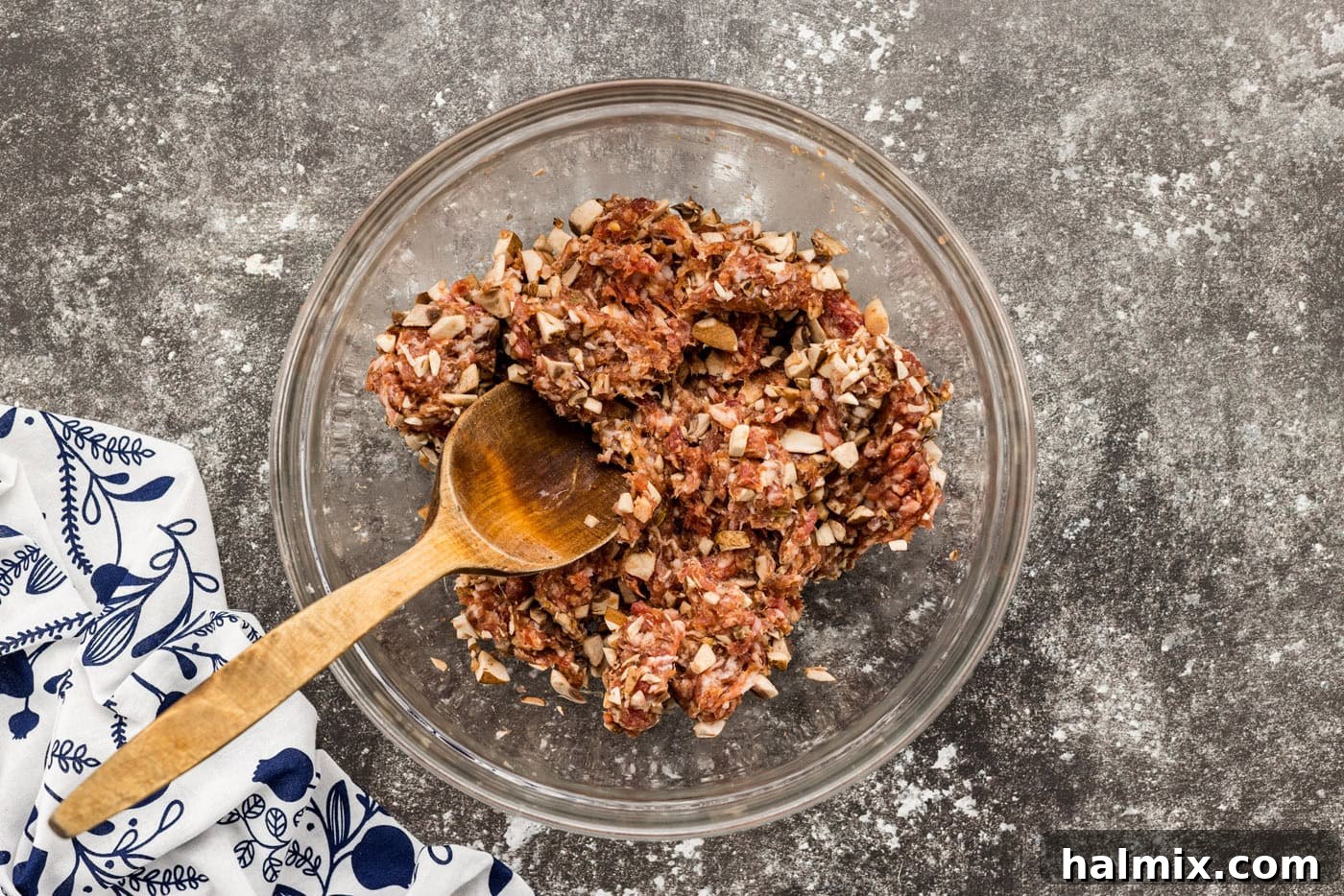 Hearty Sausage and Potato Bake 5 Mixing sausage and mushrooms in a bowl, a crucial step for a flavorful base.