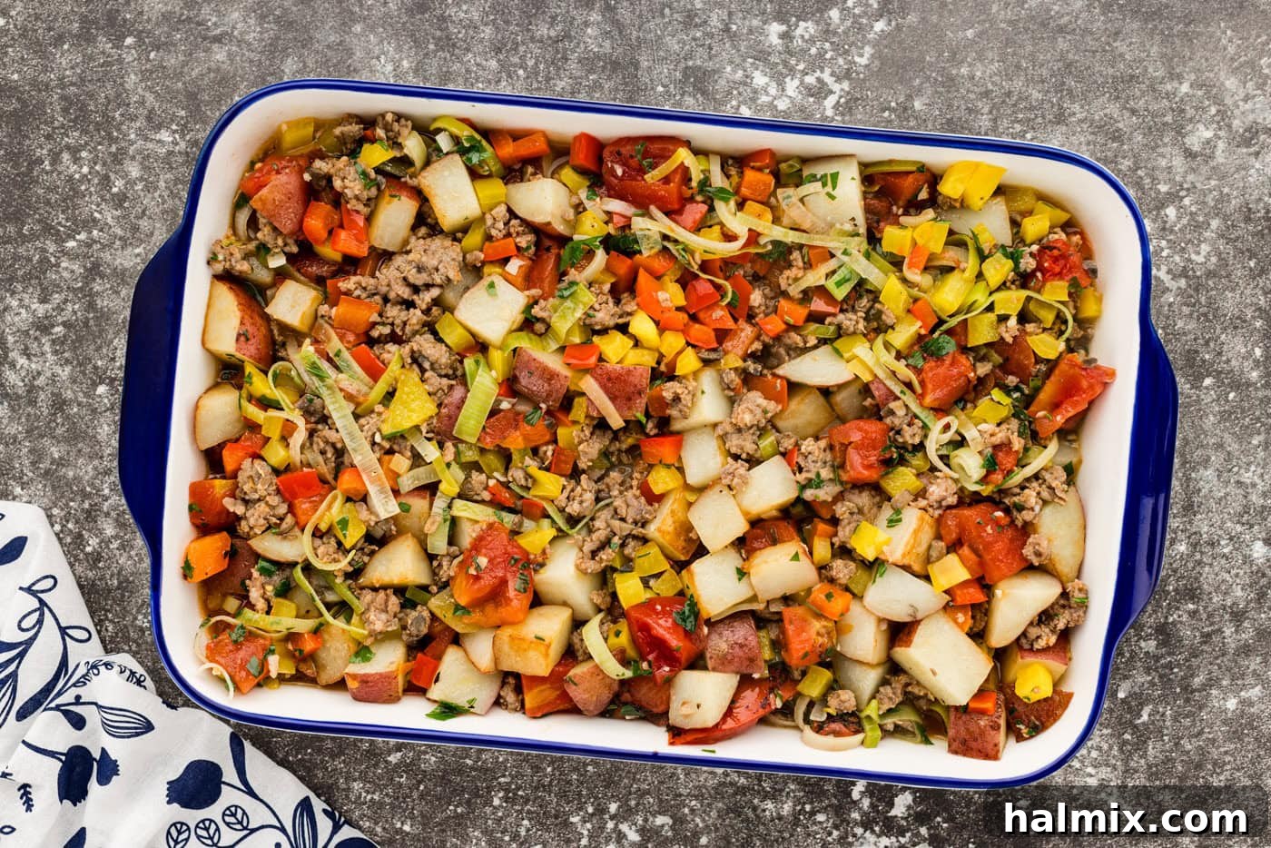 Hearty Sausage and Potato Bake 9 Sausage and potato casserole nestled in a baking dish, ready for the oven.