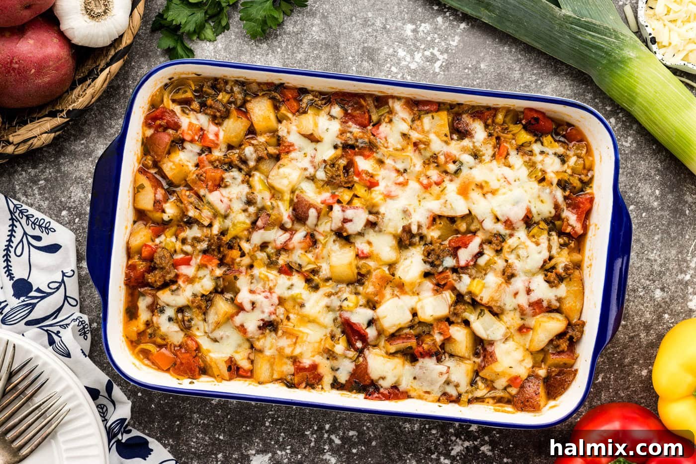 Hearty Sausage and Potato Bake 10 Overhead shot of baked cheesy sausage and potato casserole, golden and bubbling.