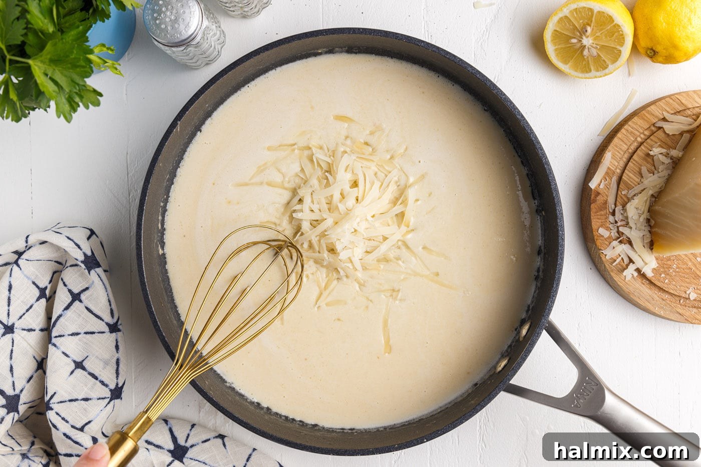 Creamy Garlic Shrimp Pasta 12 whisking freshly grated parmesan cheese into creamy lemon garlic sauce in a skillet