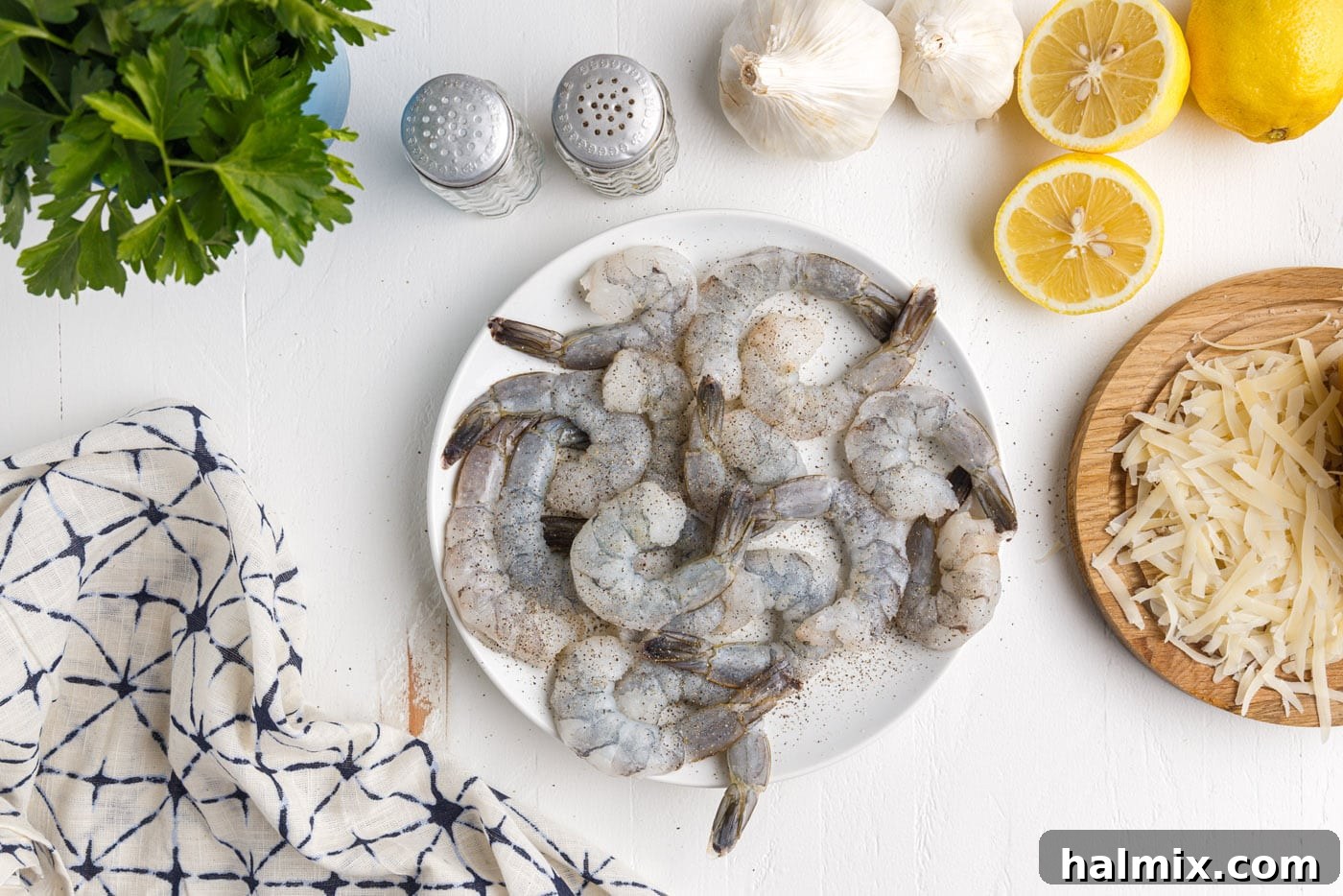 Creamy Garlic Shrimp Pasta 6 seasoned shrimp on a white plate, ready for cooking