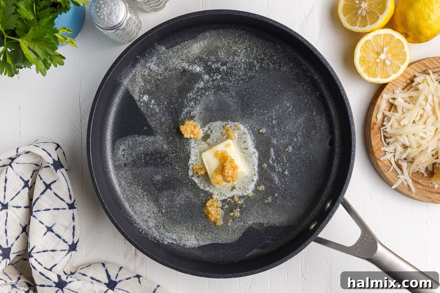 Creamy Garlic Shrimp Pasta 7 butter melting with minced garlic in a large pan
