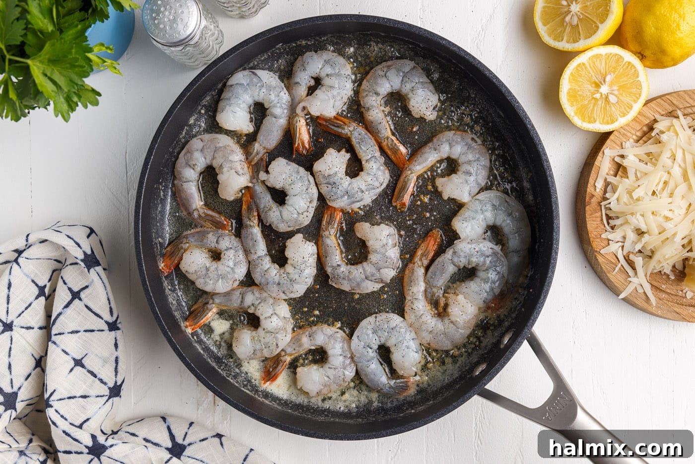 Creamy Garlic Shrimp Pasta 8 raw shrimp being added to a hot frying pan