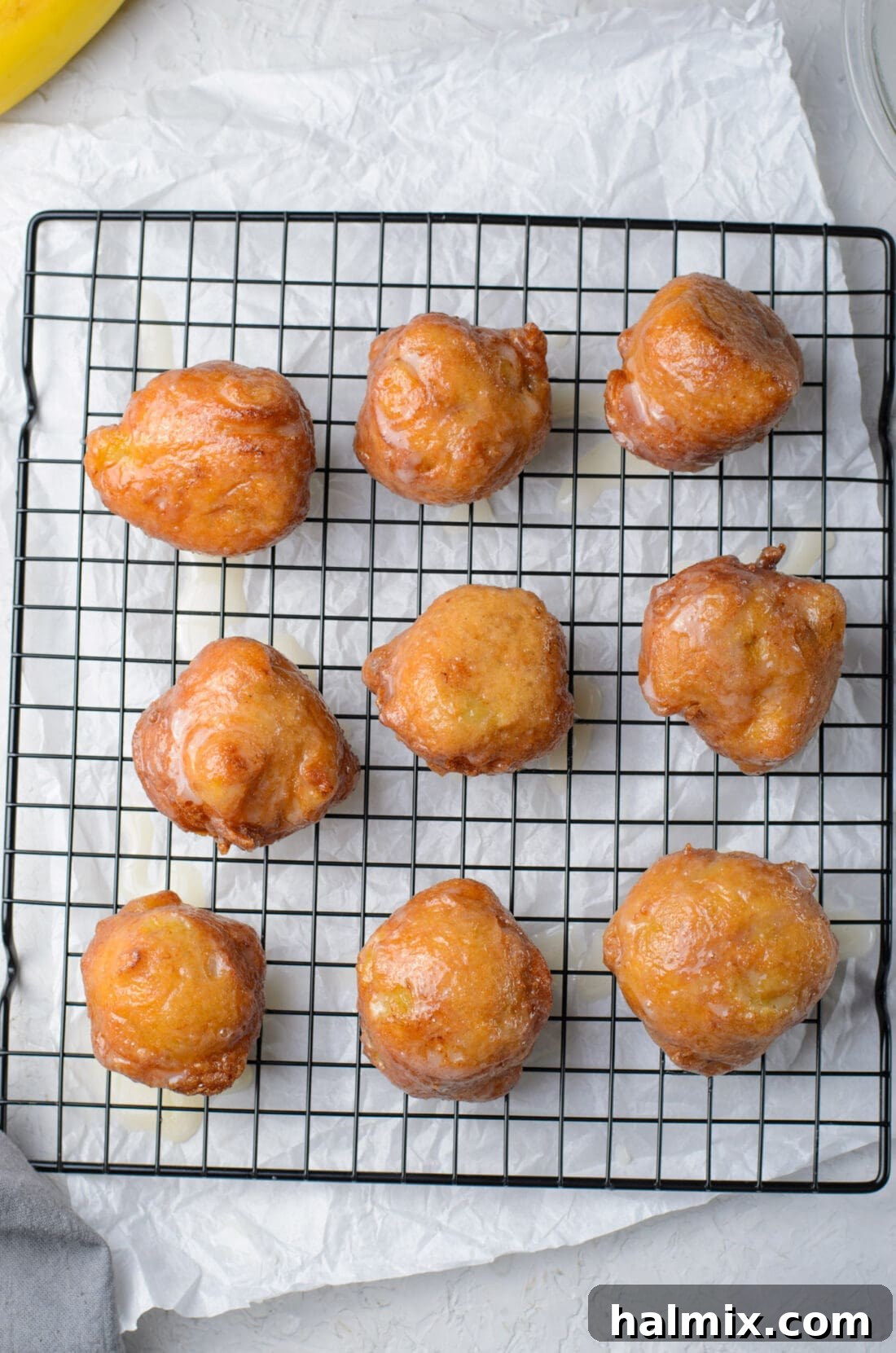 Banana Fritters on a wire rack, freshly glazed and ready to serve.