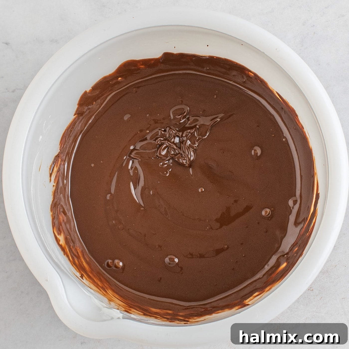 Decadent Chocolate Loaf 11 smooth melted chocolate in a bowl for the cake topping