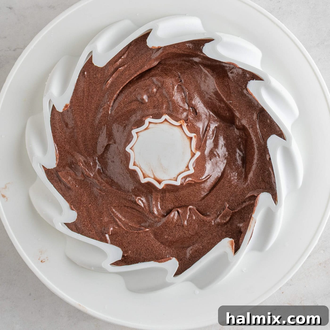Decadent Chocolate Loaf 8 chocolate pound cake batter poured into a silicone bundt pan
