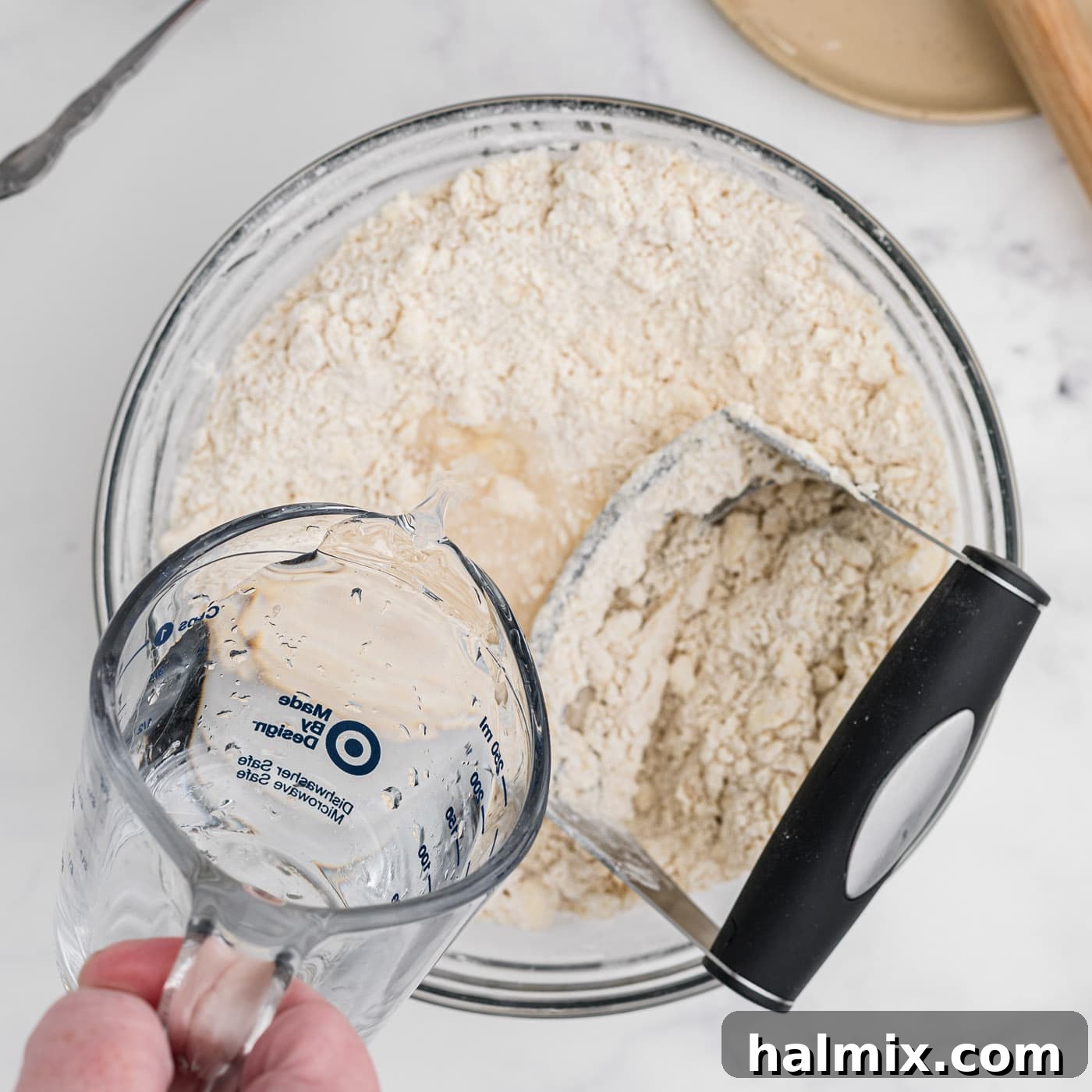 adding water to butter and flour mixture