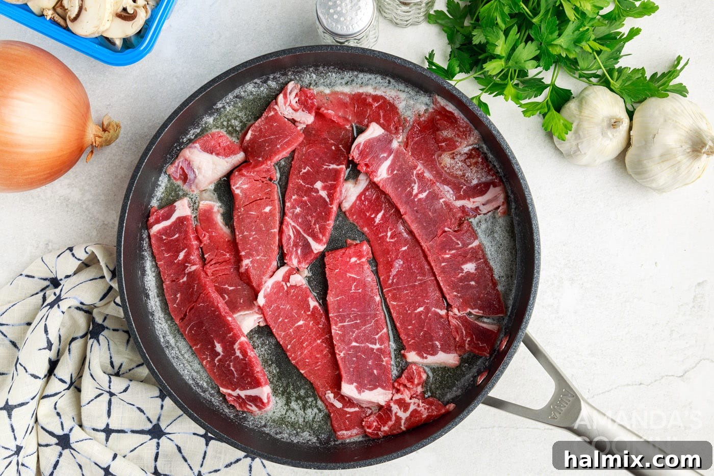 searing steak in a skillet with butter
