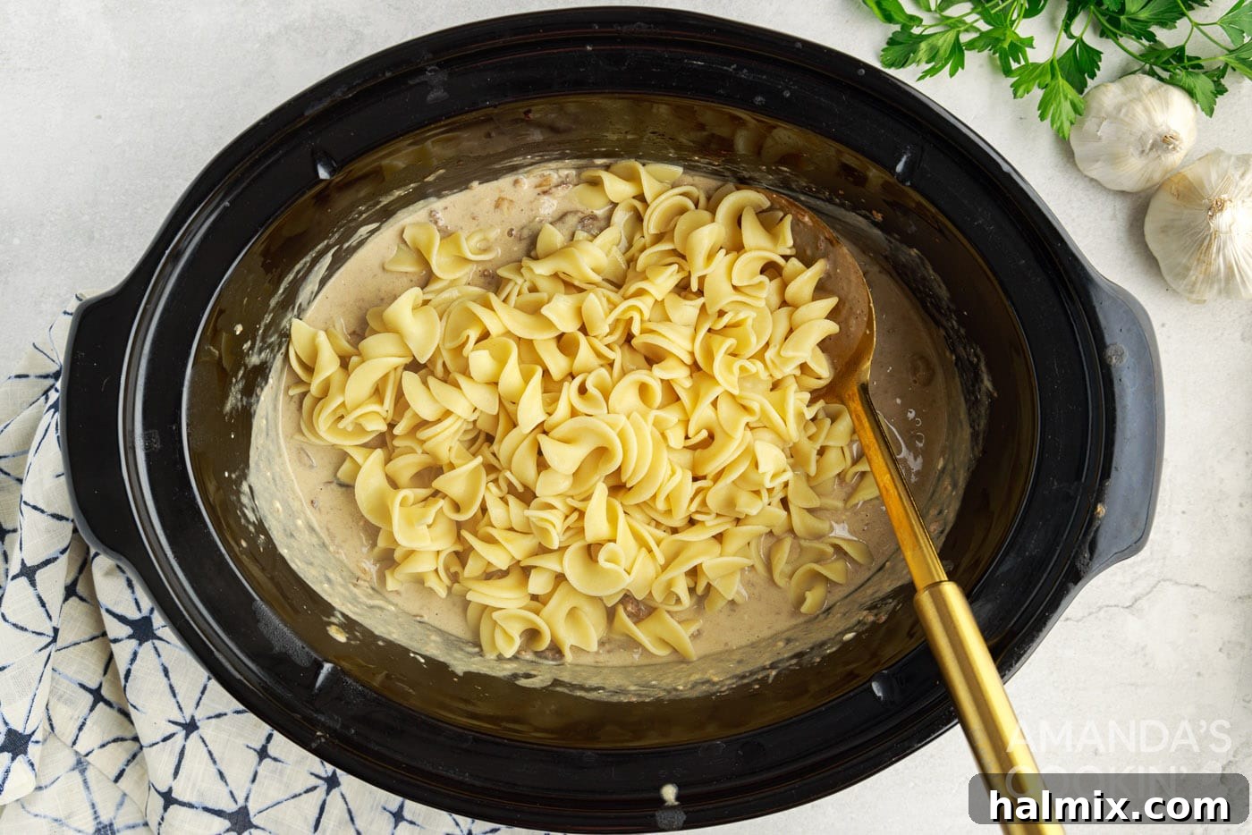 egg noodles mixed into beef stroganoff in the crockpot