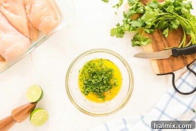 Marinade ingredients, including olive oil, lime, garlic, and cilantro, whisked in a small bowl.