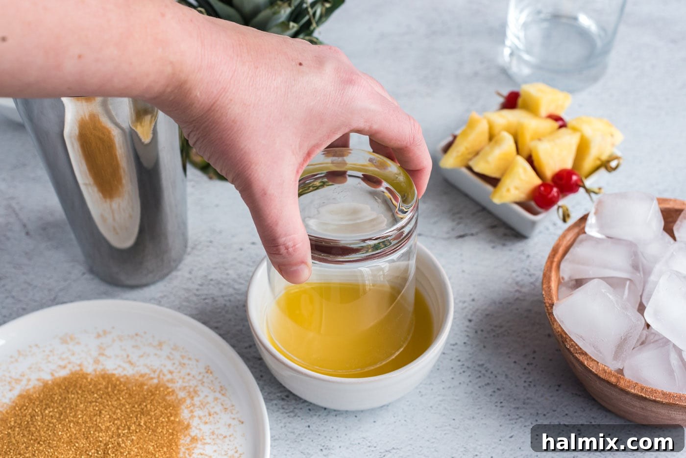Whiskey Wee Folk 5 dipping rock glass into gold sanding sugar