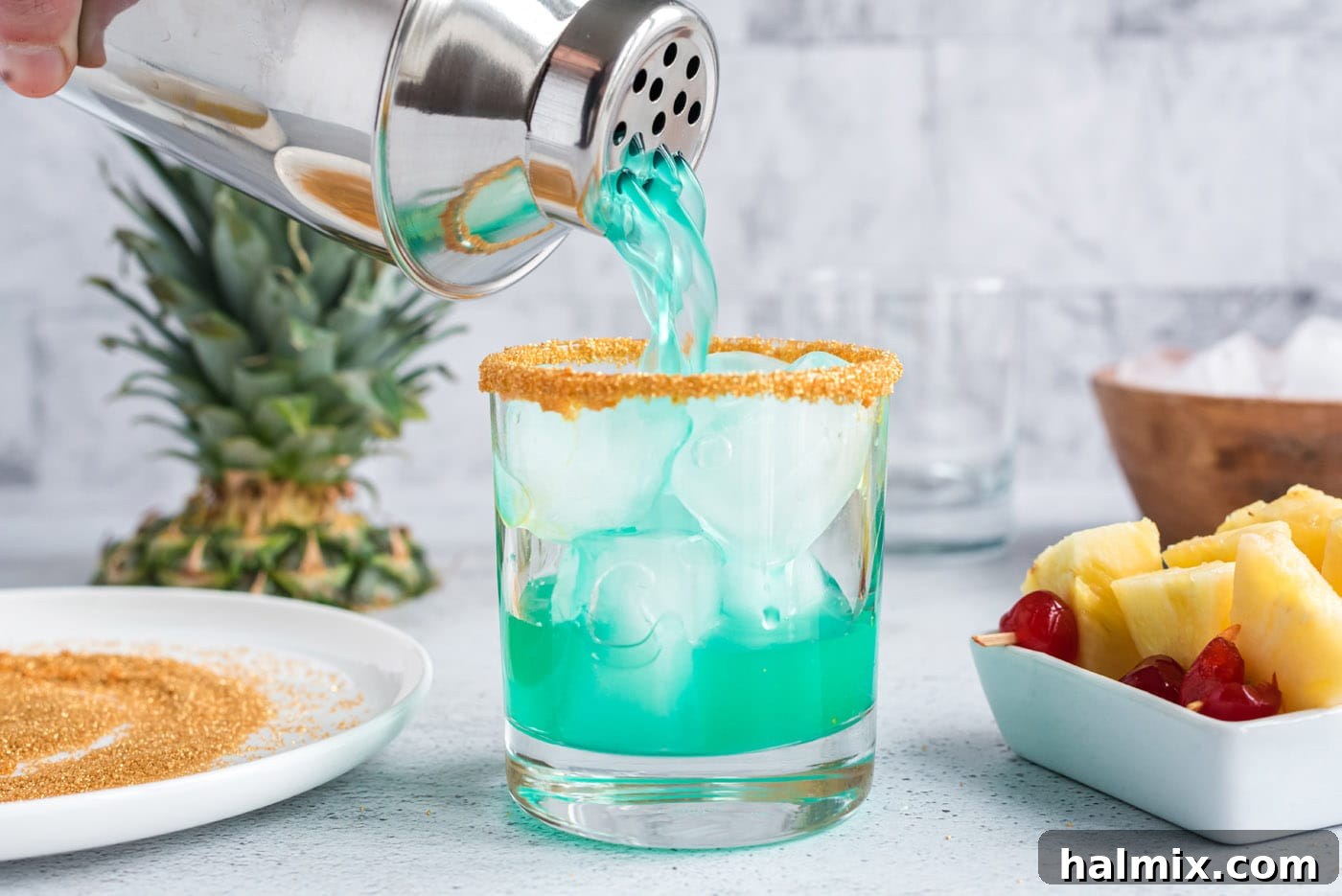pouring boozy leprechaun drink into a rock glass