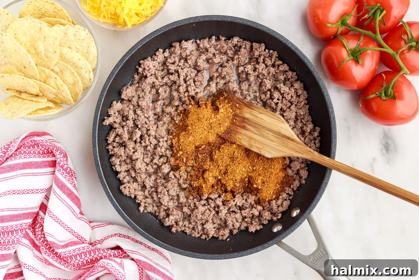 Ultimate Taco Casserole 5 Browning ground beef in a skillet with taco seasoning and water, preparing the flavorful filling for the taco pie.