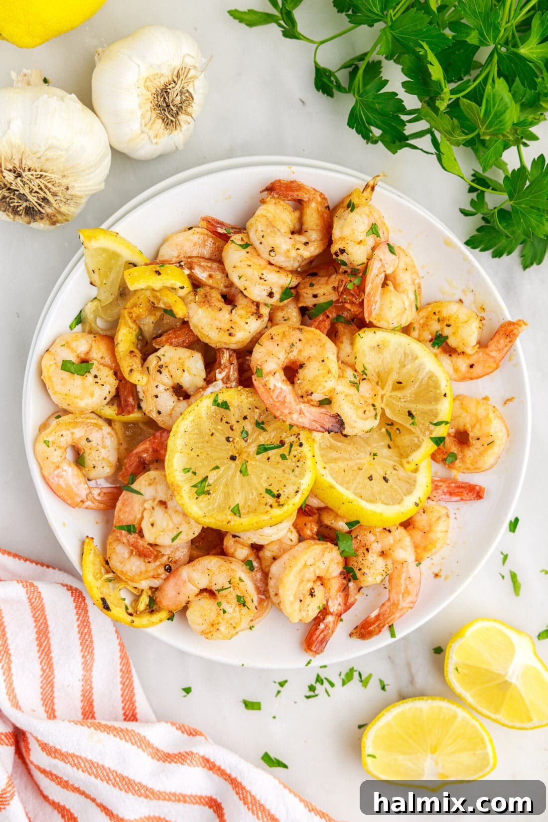 Crispy Air Fryer Shrimp 12 A beautifully plated dish of air fryer shrimp, garnished with lemon and herbs, ready to be served.