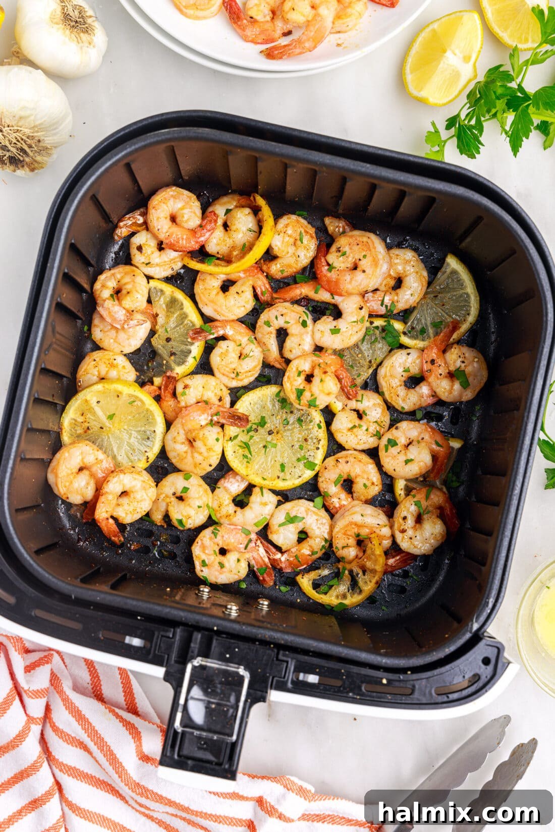 Crispy Air Fryer Shrimp 3 Close-up of raw seasoned shrimp arranged in an air fryer basket, ready for cooking.