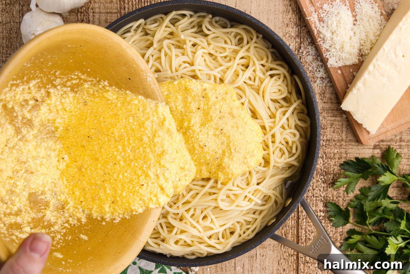 pouring egg mixture over pasta carbonara