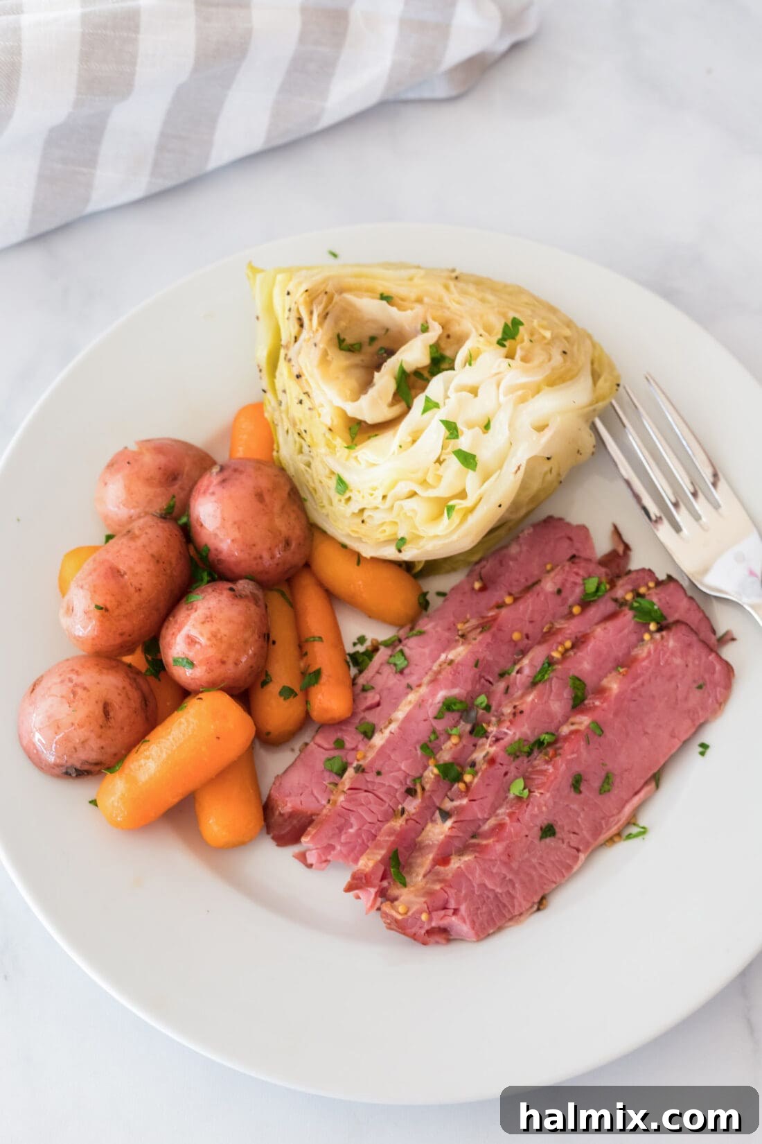 Instant Pot Corned Beef on a plate with cabbage, carrots and potatoes