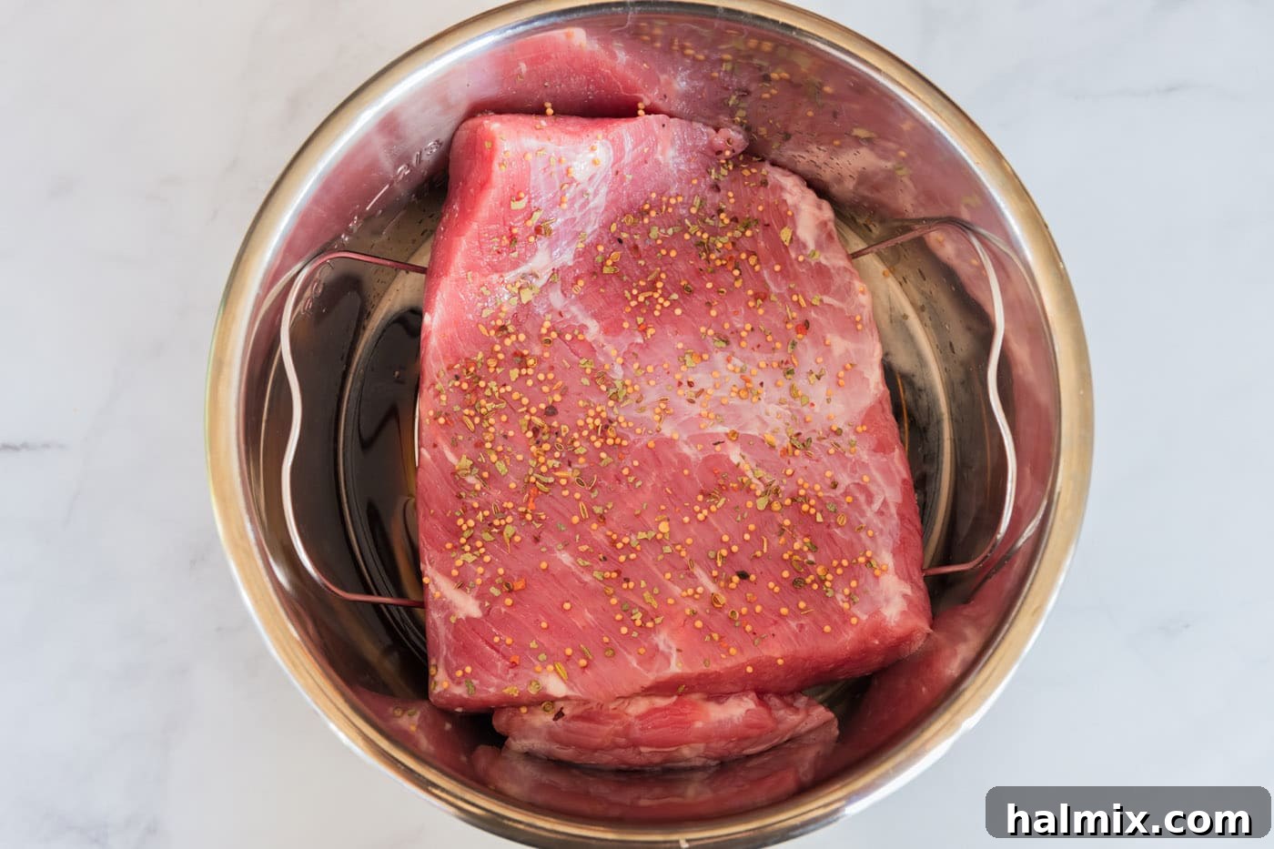 Corned beef in an Instant Pot topped with seasoning