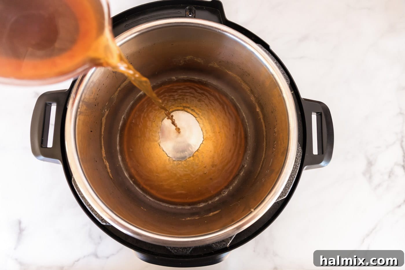 Liquid being poured back into the Instant Pot