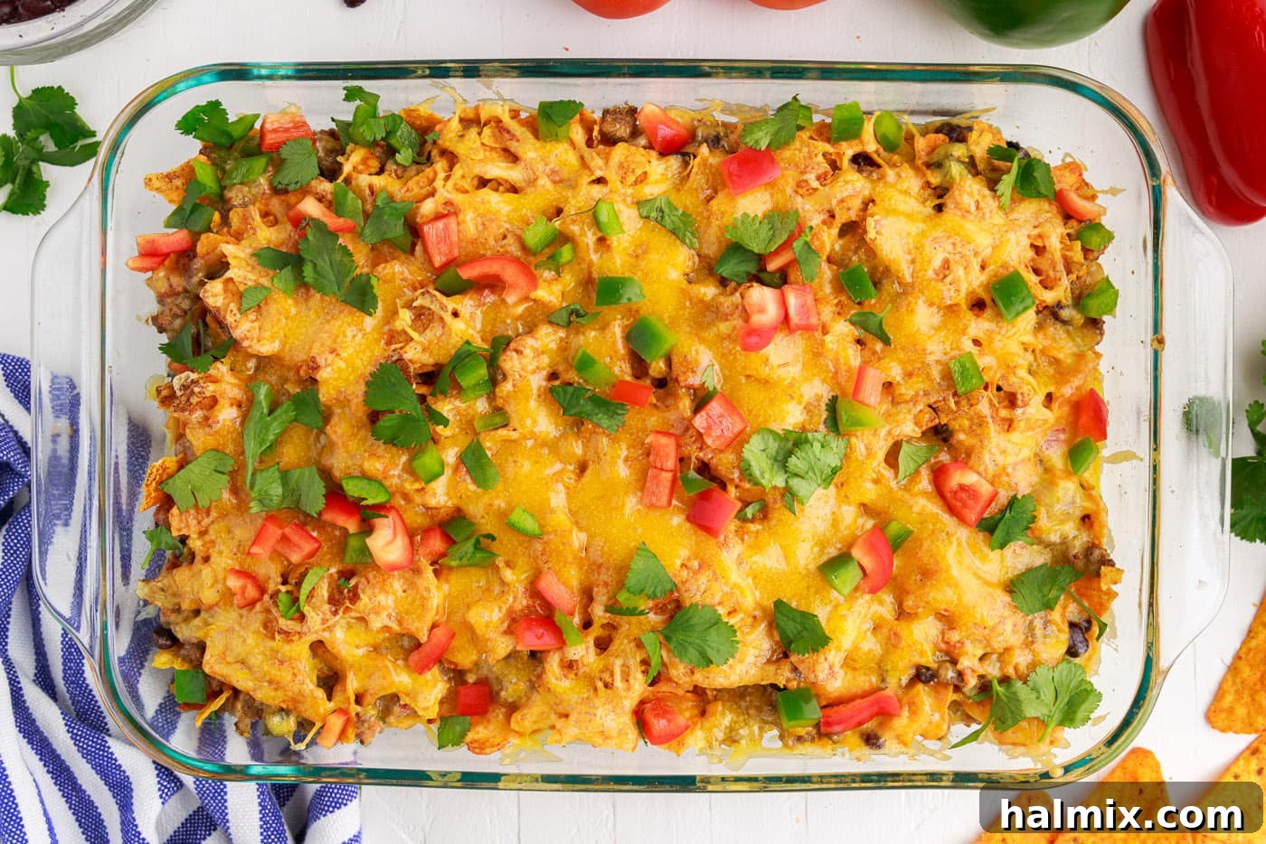 Fresh diced toppings, including bell peppers, over the finished Dorito casserole.