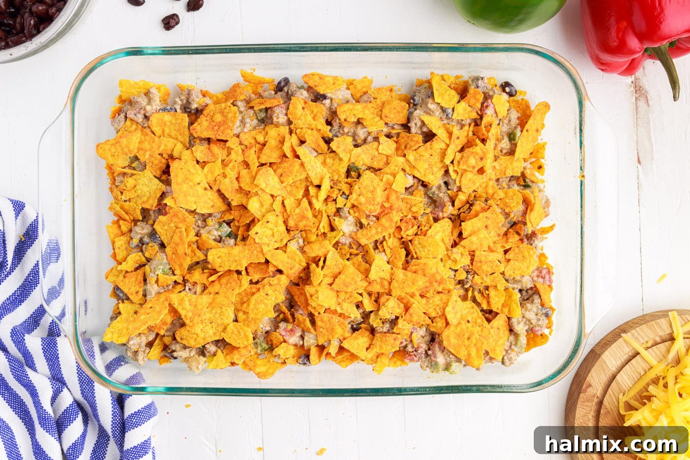 Another layer of crushed Dorito chips placed on top of the ground beef mixture.