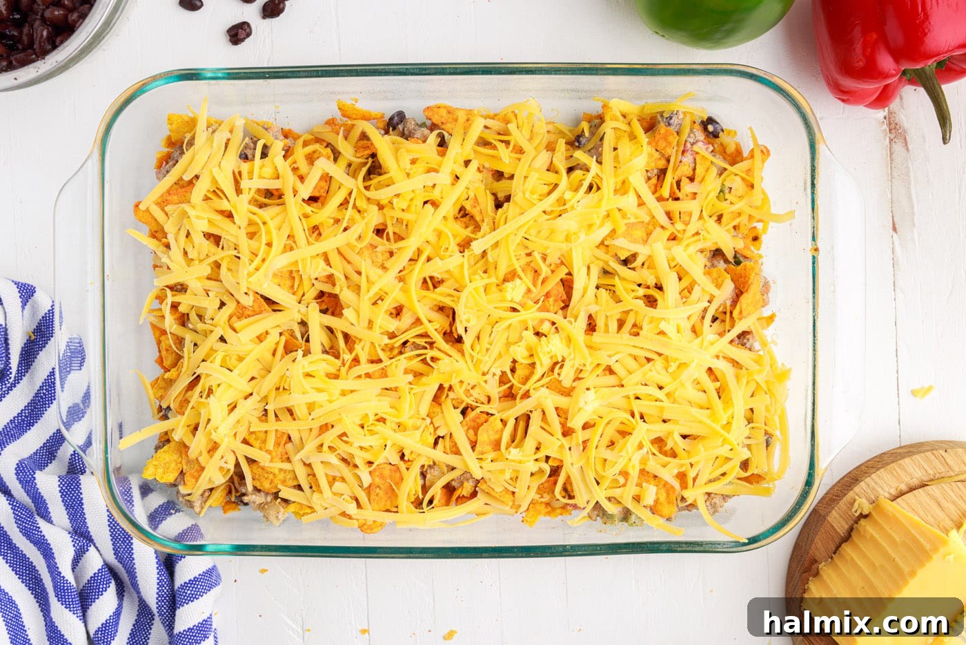 Shredded cheese spread over a layer of Doritos in the casserole.