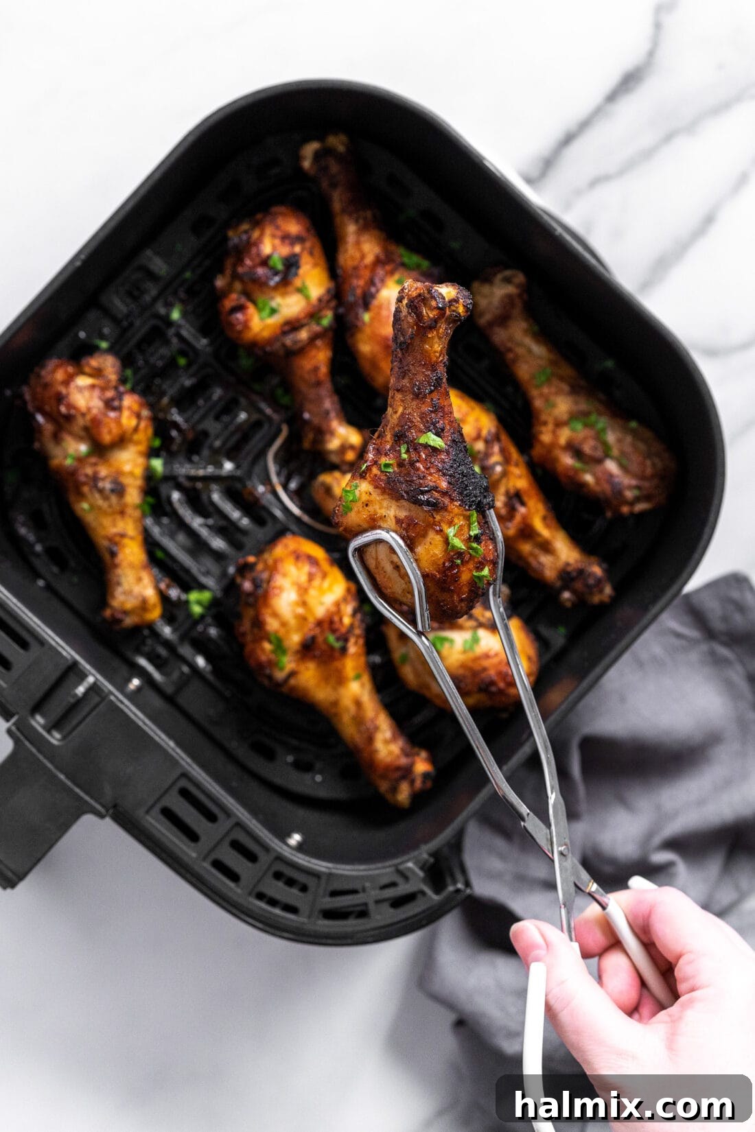 Golden Air Fried Drumsticks 3 drumsticks in an air fryer