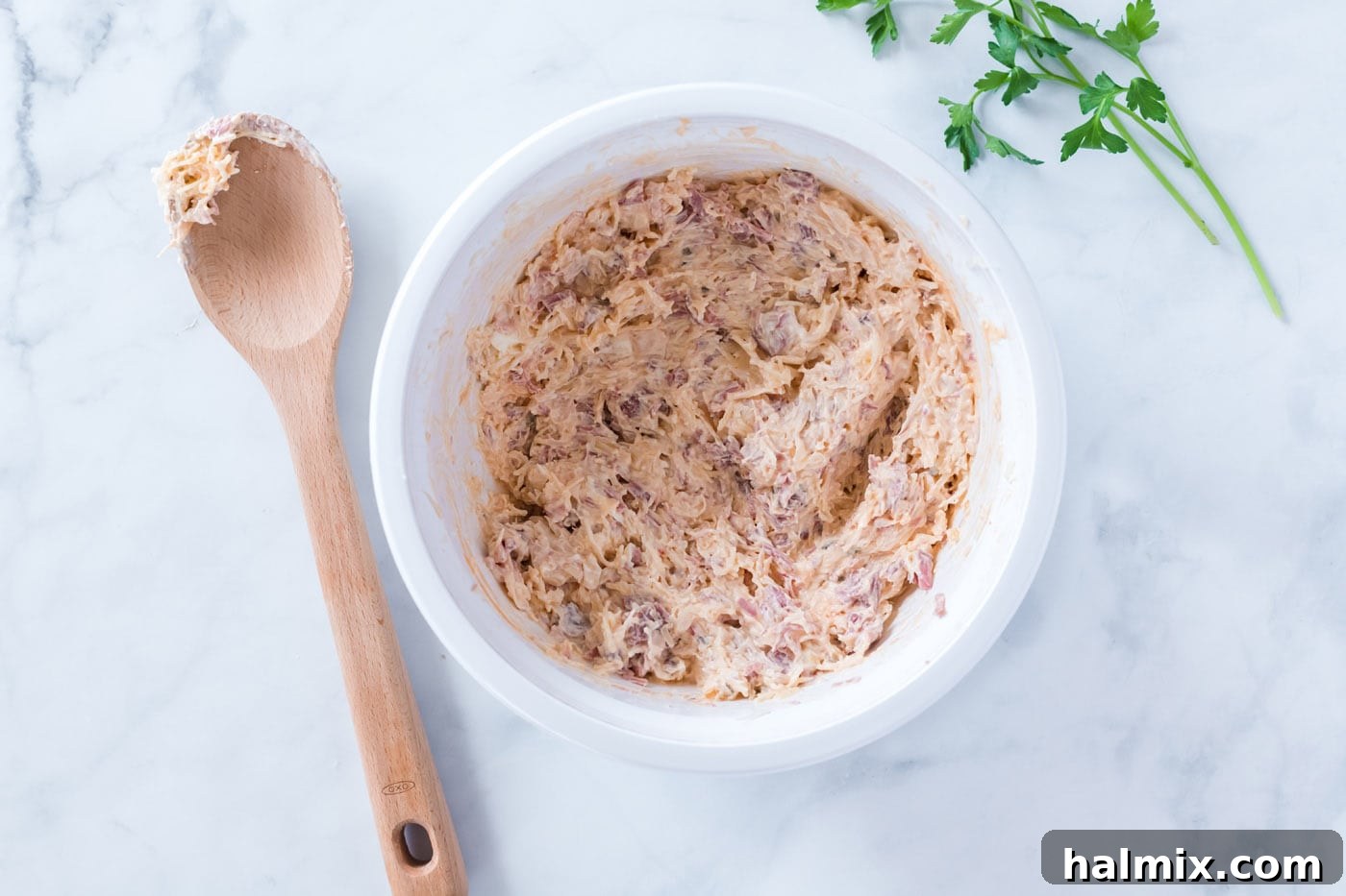 Reuben Dip mixture in a mixing bowl after ingredients have been combined, ready for baking.