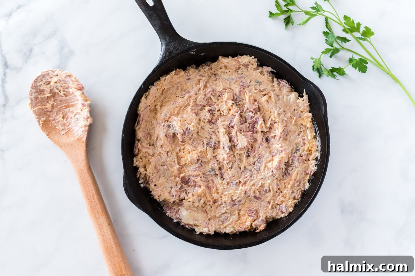 Hot and bubbly Reuben dip baked in a cast iron skillet, just out of the oven.
