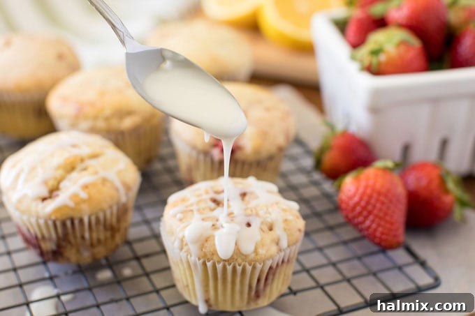 drizzling glaze over strawberry muffin