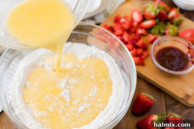 adding wet ingredients to dry ingredients in bowl