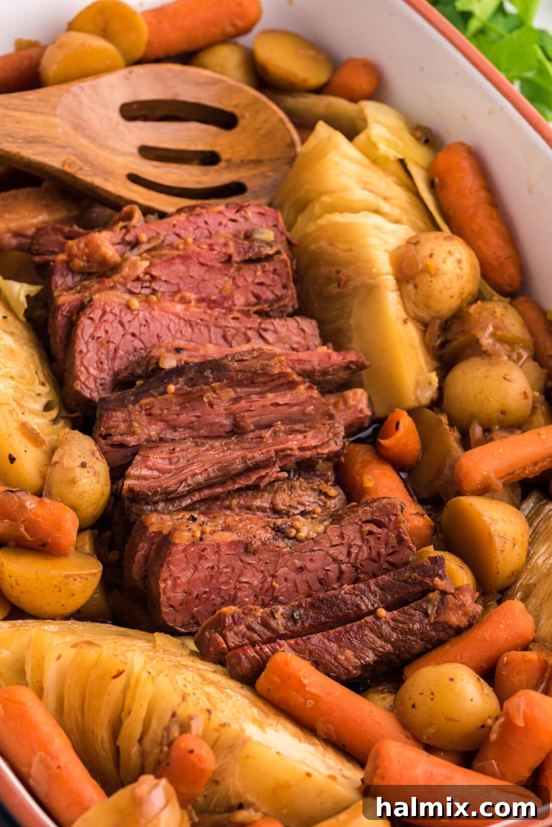 Crockpot Corned Beef with a wooden spoon