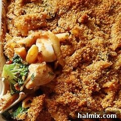 A close up photo of baked penne with chicken, broccoli and smoked gouda.