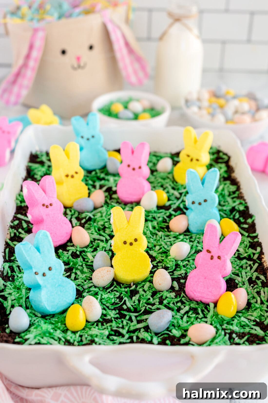 Festive Easter Dirt Cake Decorated with Bunnies and Eggs Easter Dirt Cake with vibrant decorations including Peeps bunnies and candy eggs