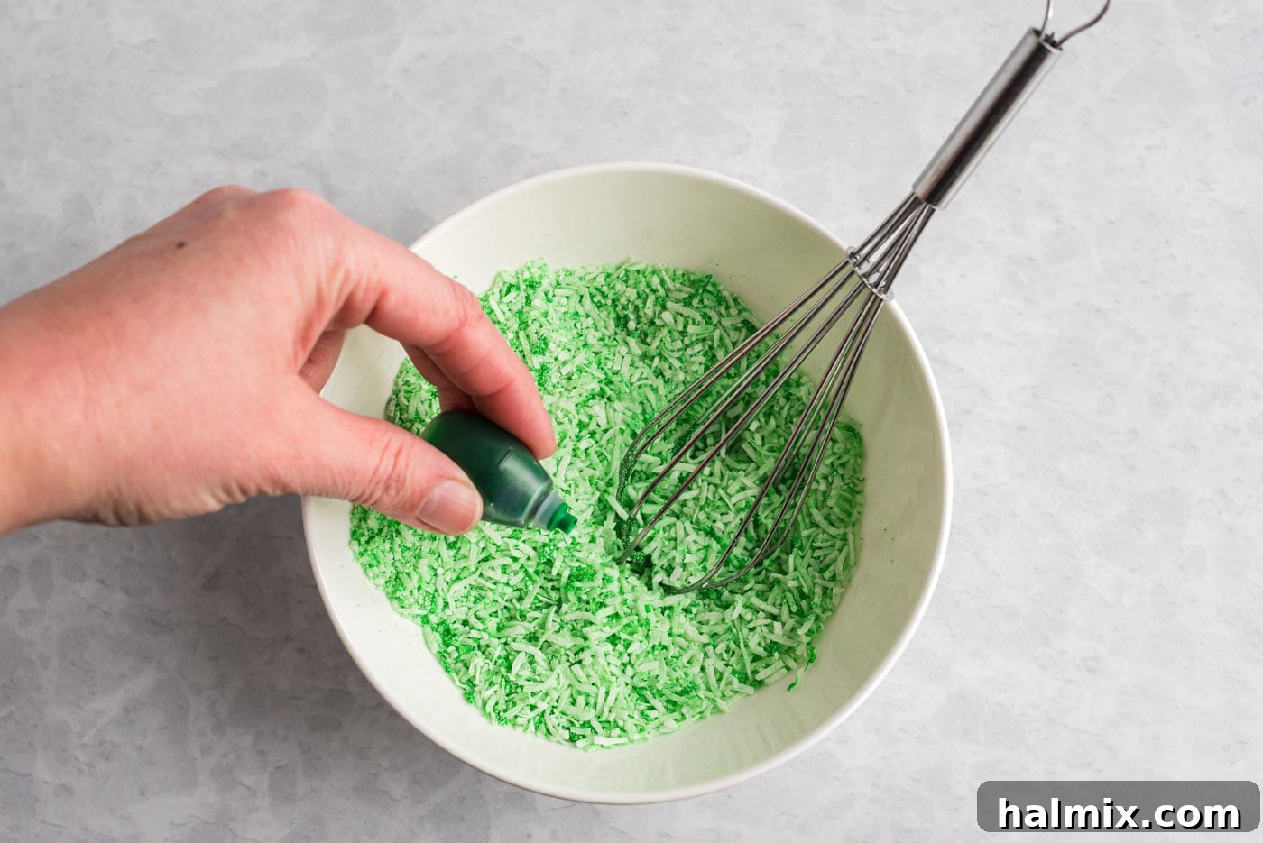 Creating Green Coconut Grass Mixing green food coloring with shredded coconut for grass