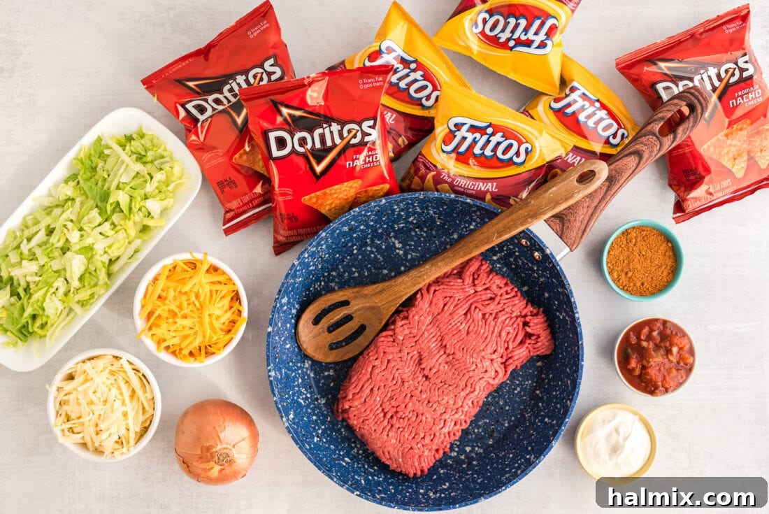 A vibrant flat lay of Walking Taco ingredients, including ground beef, taco seasoning, various chips, and fresh toppings