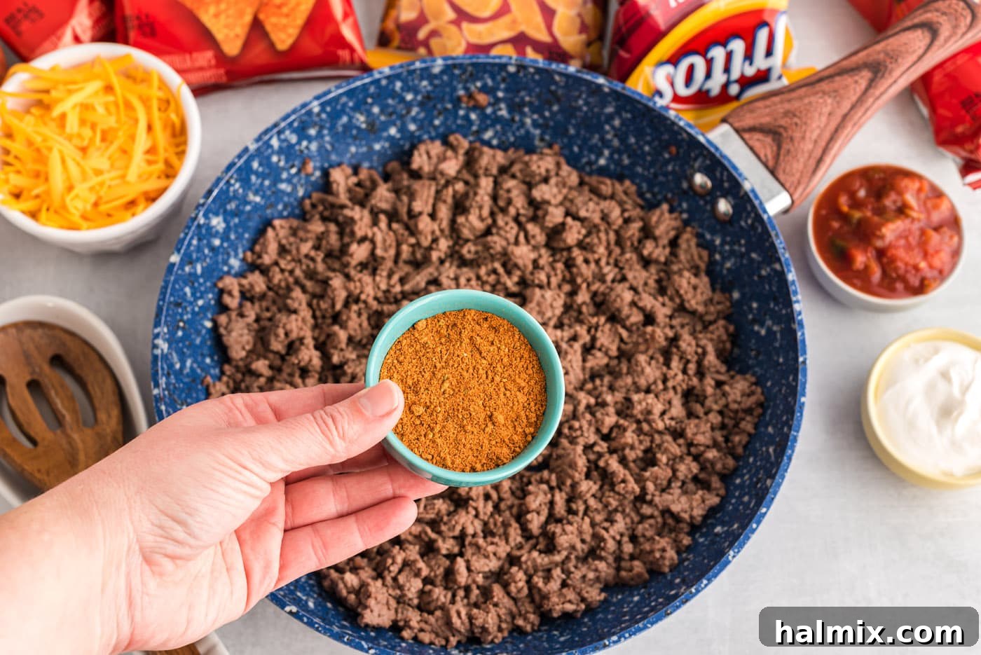 Ground beef and taco seasoning simmering in a skillet